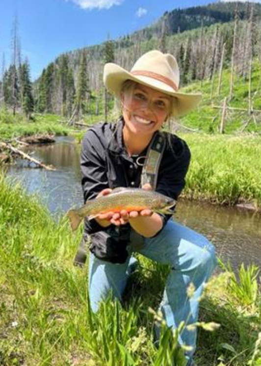Woman holding fish she caught
